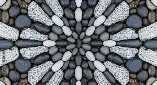 Symmetrical Zen Mandala Pattern Composed of Smooth Black and White River Pebbles and Stones