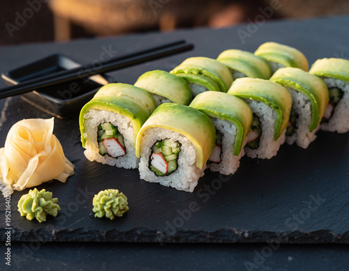 Fresh Avocado Sushi Rolls with Crab and Cucumber on Black Slate Board
