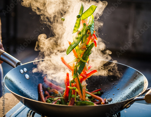 Stir-frying fresh vegetables in a hot wok with steam and dynamic motion