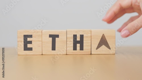 Hand change Wooden block with ETH or Ethereum text to UP and Down arrow symbol. cryptocurrency, blockchain, price, down and up, decrease and increase, cut loss, trade and financial concepts