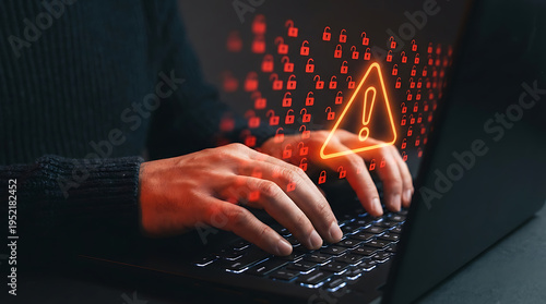 A person types on a laptop keyboard with a warning symbol and red binary code displayed on the screen in the background
