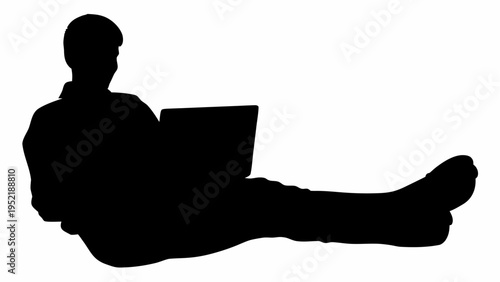 Silhouette of a relaxed person working on laptop in a casual home office setting with comfort