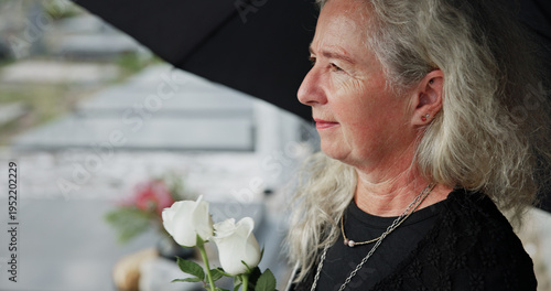 Slika na platnu Elderly, woman and umbrella at cemetery with flowers, grieving loved one and thinking about past memory