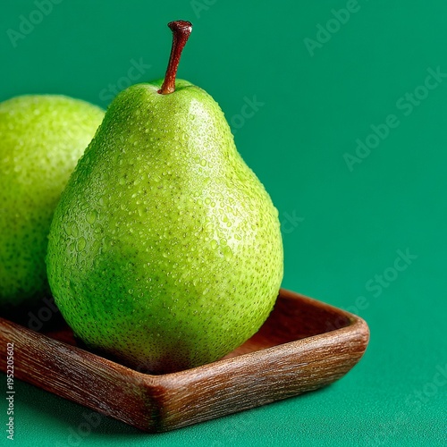 Fresh green pear on rustic oak tray with soft natural lighting
