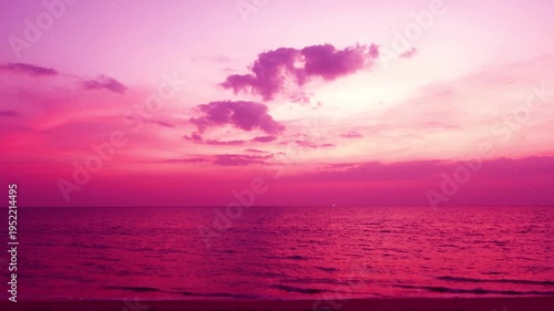 4k Magenta purple sunset beach n Gradient Pastel pink sky background with dramatic dark rain storm clouds n wispy smoke cloudscape over calm ocean wave n sea water in tropical summer sunlight sun ray