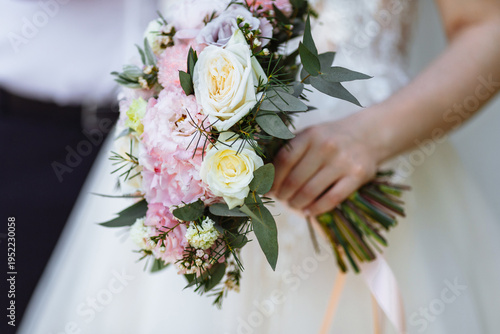 the bride holds a wedding bouquet