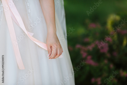 bride holding a ribbon in her hand