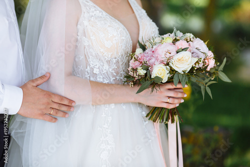 the bride holds a wedding bouquet