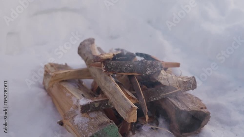 Wallpaper Mural Close view of a small campfire smoldering in a snow pit surrounded by deep snow. Smoke slowly drifts upward while the firewood continues burning. High quality 4k footage Torontodigital.ca