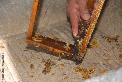 Removing honeycomb residue with knife close up
