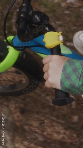 Wallpaper Mural Close view of a child riding a bicycle through a forest path with focus on hands and bike frame. Vertical video showing movement, coordination, and active outdoor childhood. Face is not visible. 4k Torontodigital.ca