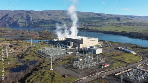 4K Aerial drone footage of a large data center campus with cooling steam, electrical substation along the Columbia River in The Dalles, Oregon, USA. Power demand for cloud computing AI infrastructure