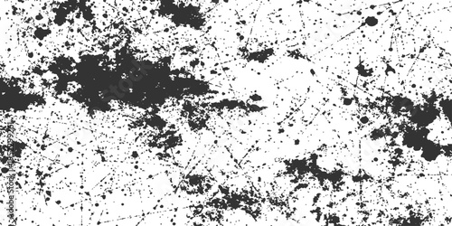 A striking monochromatic image of a textured surface, showcasing a random spray pattern. The contrast between dark ink splotches and a pristine background evokes a sense of artistic experimentation.