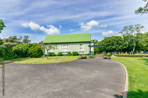 Green Roof Cottage Beside Garden Under Blue Sky