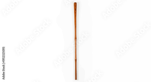 A long, slender wooden rod, possibly a wand, with a light brown color on a white backdrop
