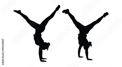 Silhouettes of two people performing handstands with legs extended upward