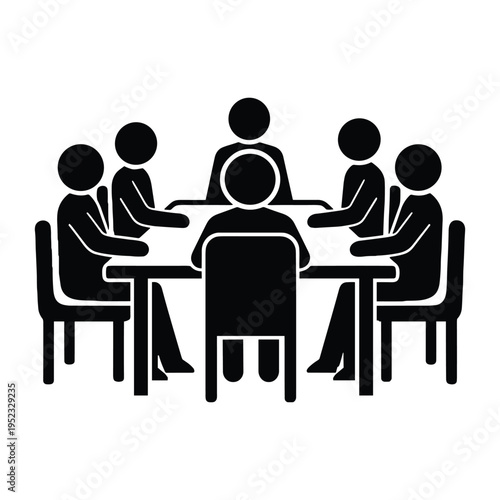 A group of people sitting around a table in a meeting
