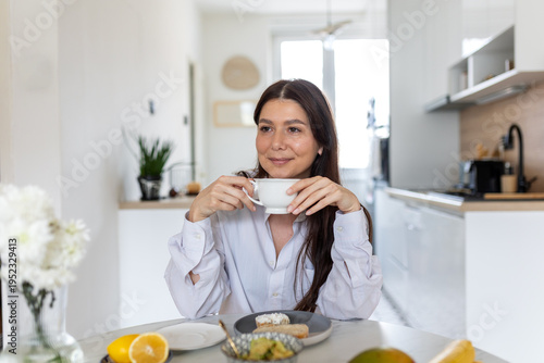 Canvas Print Healthy breakfast scene with a young woman drinking coffee and eating fresh fruit