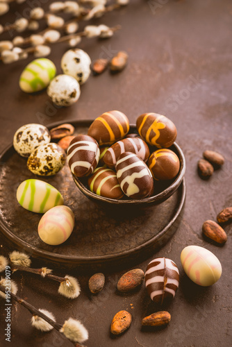 Sweet chocolate eggs with cocoa beans in brown tone for Easter