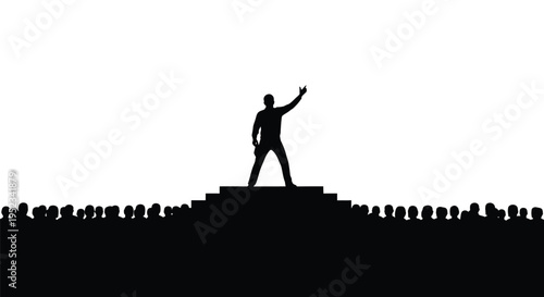 Man raising hand on stage before large crowd stark silhouette