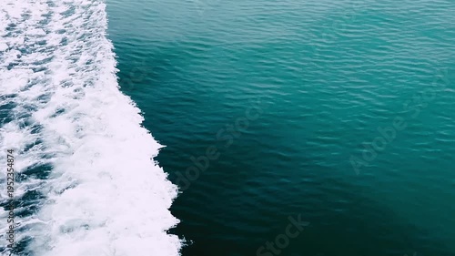 A stunning shot of the ocean, capturing the gentle flow of water and white foam
