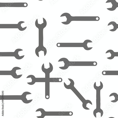 A seamless pattern of grey wrenches on a white background