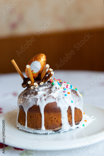 Easter cake with eggs on a plate is on the table