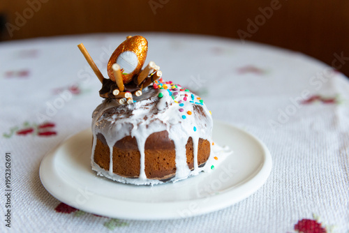 Easter cake with eggs on a plate is on the table