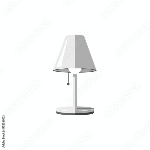 A grey desk lamp with a conical shade stands on a circular base
