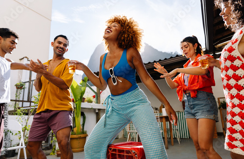 Friends dancing together at an outdoor gathering in Rio de Janeiro
