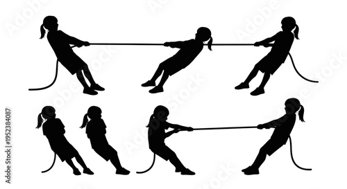 Silhouette of children playing tug of war, symbolizing teamwork and competition