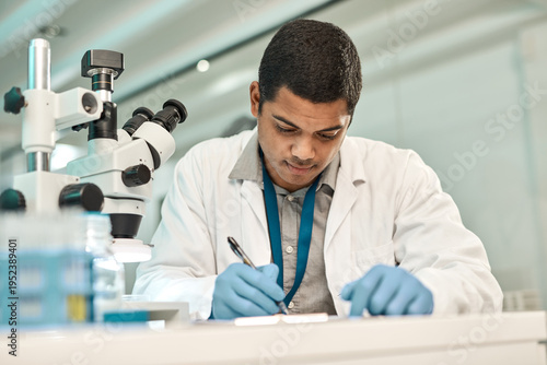Foto Man, scientist and writing on paperwork in lab for research, medical report and experiment results