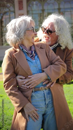 An exuberant elderly couple enjoying a lively moment filled with laughter, joy, and affection, showcasing their deep bond and shared happiness in a delightful interaction full of love and warmth.