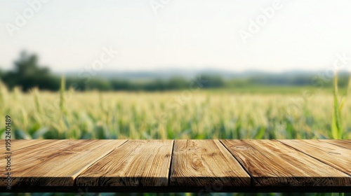 Wooden table surface overlooking blurred golden wheat field, representing agricultural landscape with space for product presentation