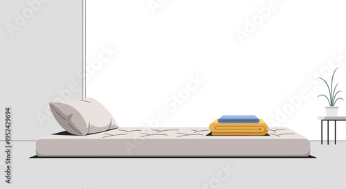 Minimalist bedroom setup with mattress, pillow, and folded blankets on a side table.