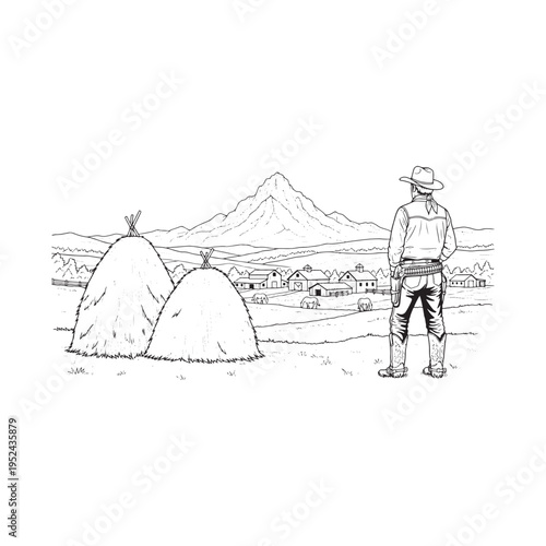 Cowboy standing in a field looking out at a mountain