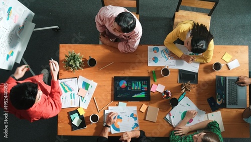 Top view of attractive diverse team clapping hands while project manager present creative idea at meeting room. Diverse team working together planning marketing strategy at meeting room. Convocation.