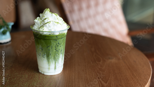 Iced matcha latte layered with milk and topped with crunchy brown sugar waffle pieces