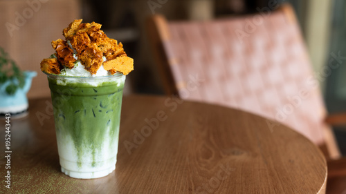 Iced matcha latte layered with milk and topped with crunchy brown sugar waffle pieces