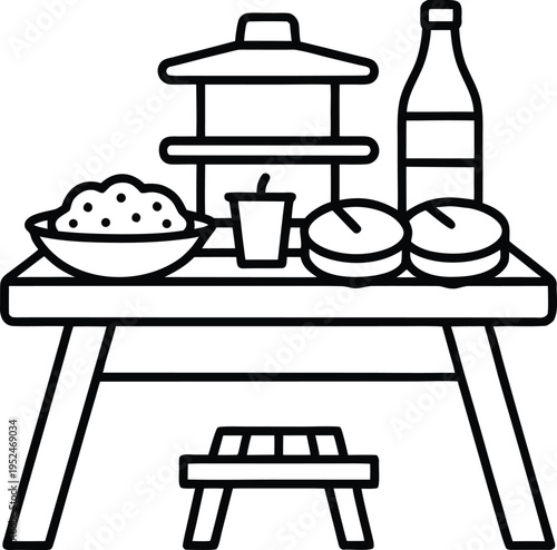 Bento box and food on a picnic table outdoors