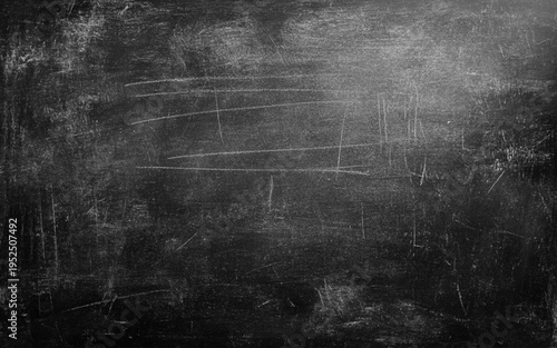 Chalkboard Wall Texture. A black or dark gray chalkboard surface with a slightly rough texture, often with faint chalk smudges, used for educational 