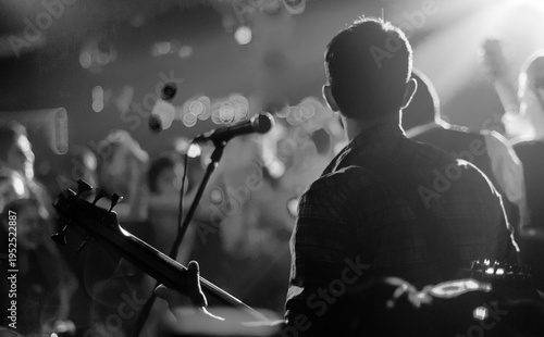 Photos Musician performing bass guitar in live concert