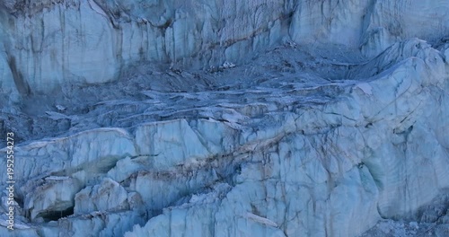 Close aerial drone view of glacier snow chunk formations and compact ice structures near Lobuche Peak in the high-altitude Himalayan terrain of the Everest region, Nepal.