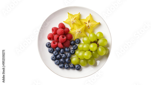 Isolated plate of fresh mixed fruits including raspberries, blueberries, star fruit, and green grapes