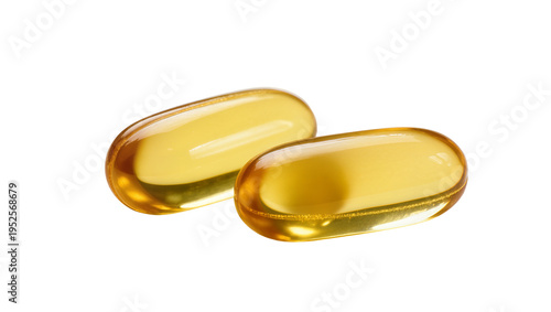 Slika na platnu Two shiny yellow softgel capsules, isolated on transparent background, represent