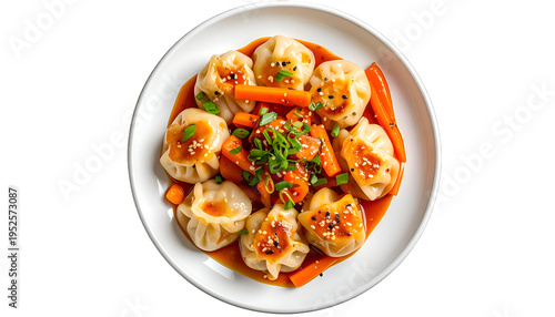 A close-up, top-down view of dumplings with carrots and sauce on a white plate