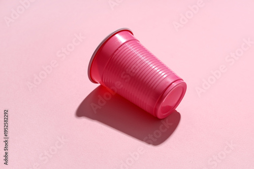 Pink plastic cups on color ...