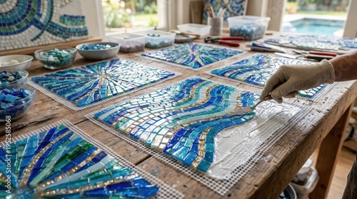 Close medium shot of decorative glass mosaic sheets being prepared showcasing glossy pieces arranged for stunning outdoor pool accents.