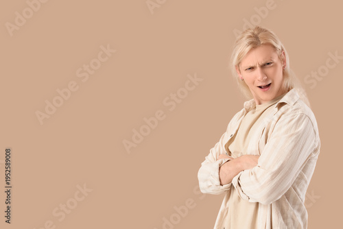 Shocked young blonde man on...