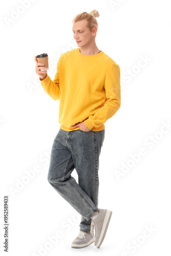 Young blonde man with cup o...